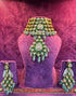 Ornate green and gold POLKI jewelry set on a purple mannequin with &