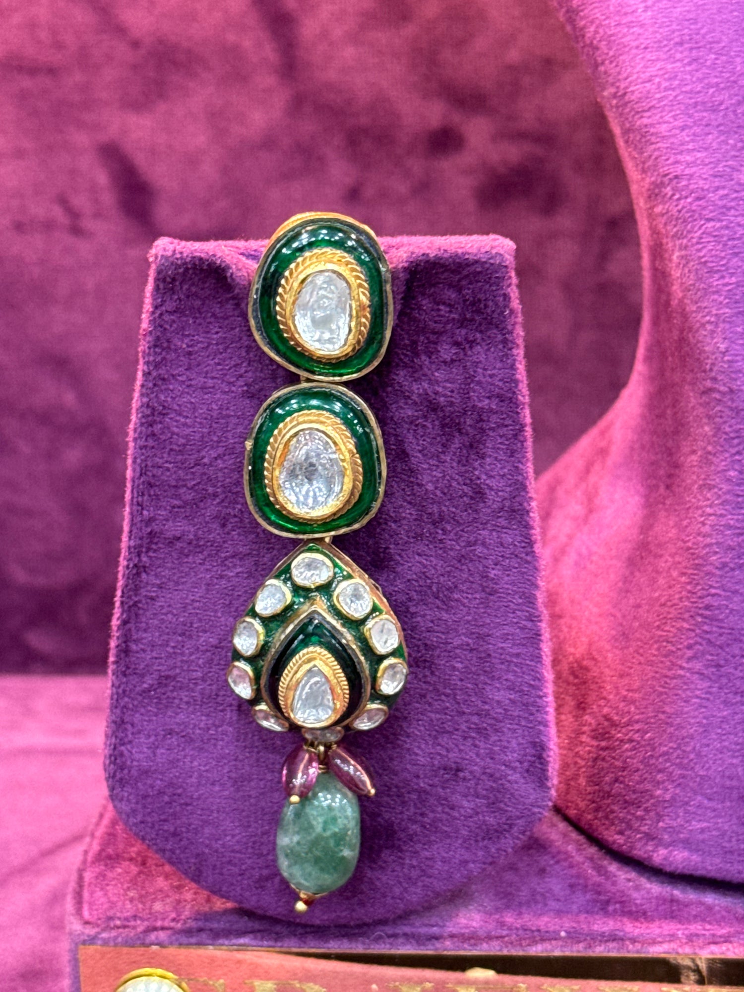 Polki earrings on a purple stand with a pink background "SP. Jewellers"