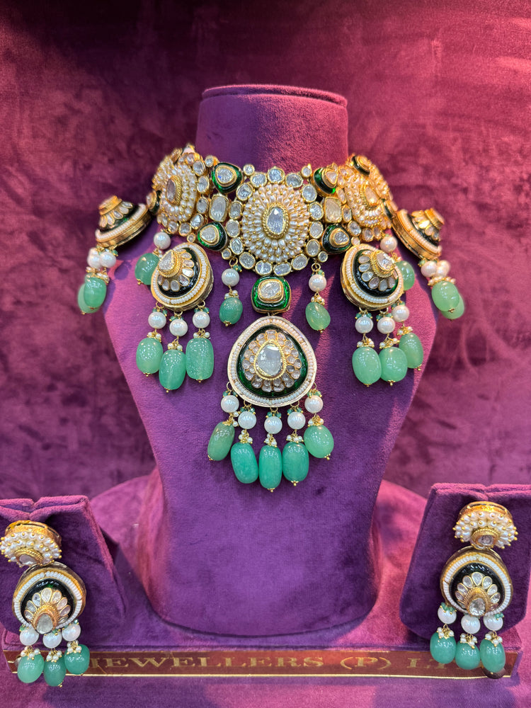 Polki necklace set green and gold jewelry set on a purple mannequin bust with "SP. Jewellers" branding.