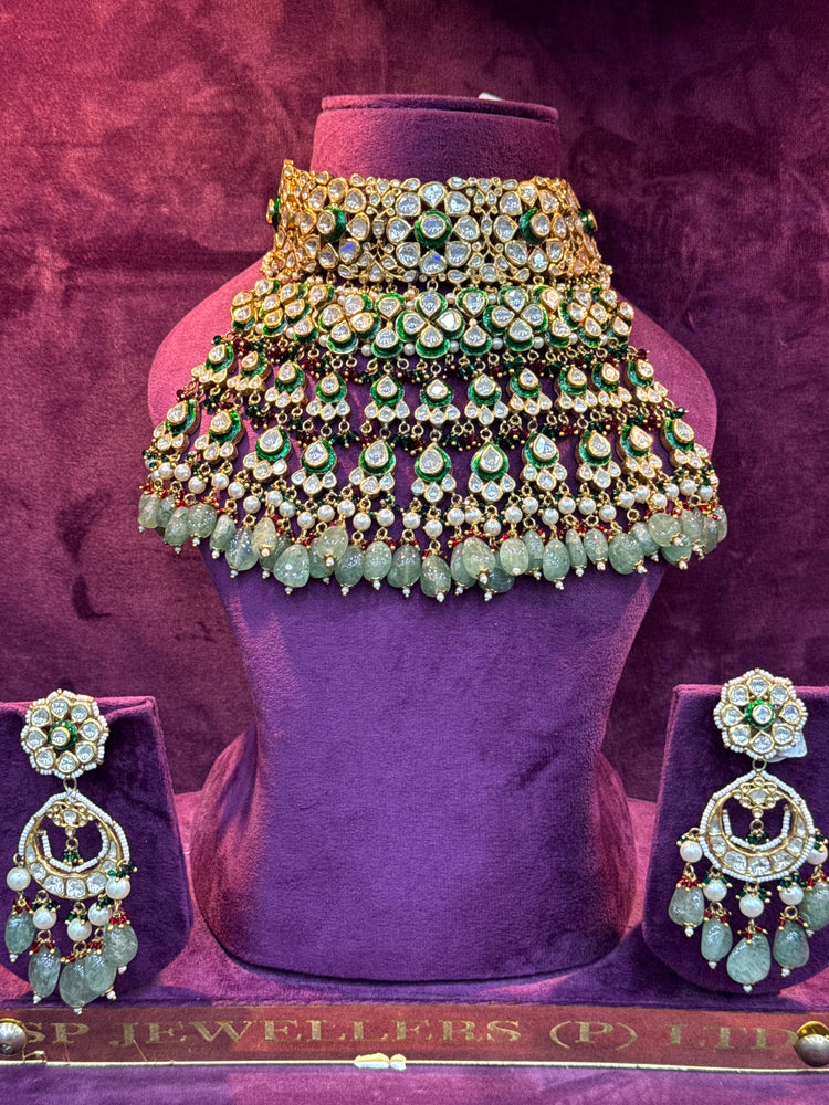 Polki  necklace and earrings set on a purple stand with a textured purple background "SP. Jewellers"