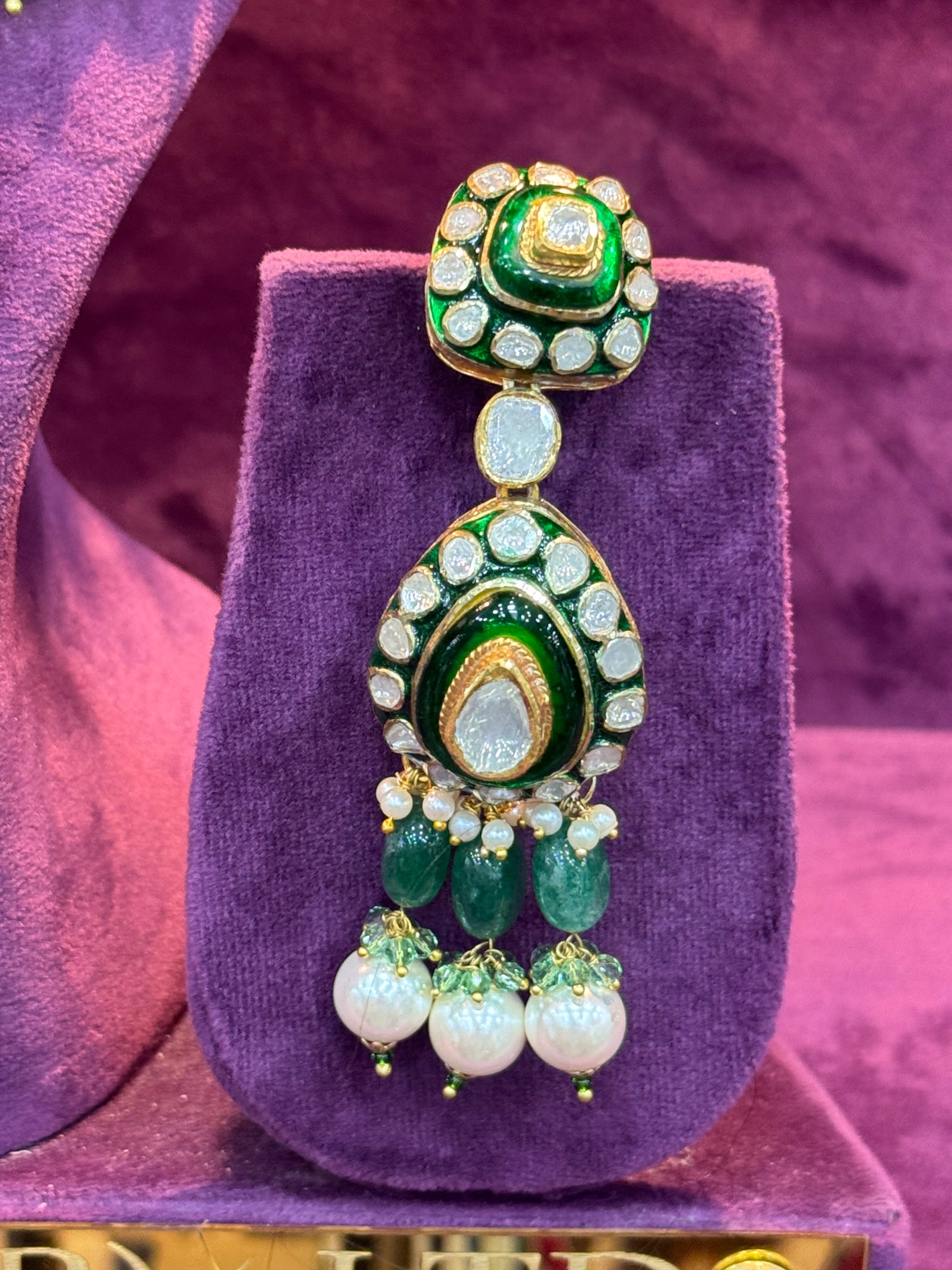 Decorative Polki earrings on a purple stand with a purple background "SP. Jewellry"