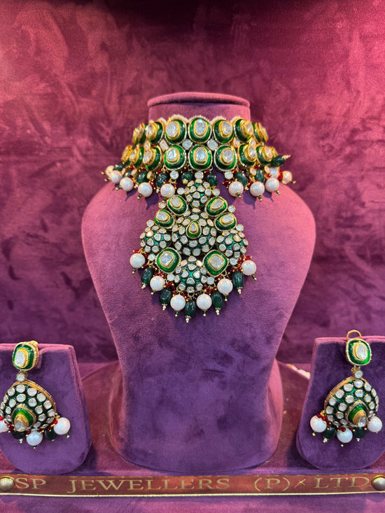 Polki Jewelry set with necklace, earrings, and ring on a purple stand with &